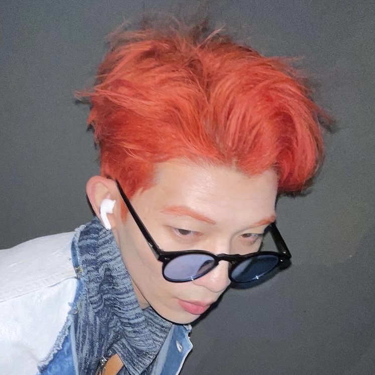 A man with a red hair and a blue glasses